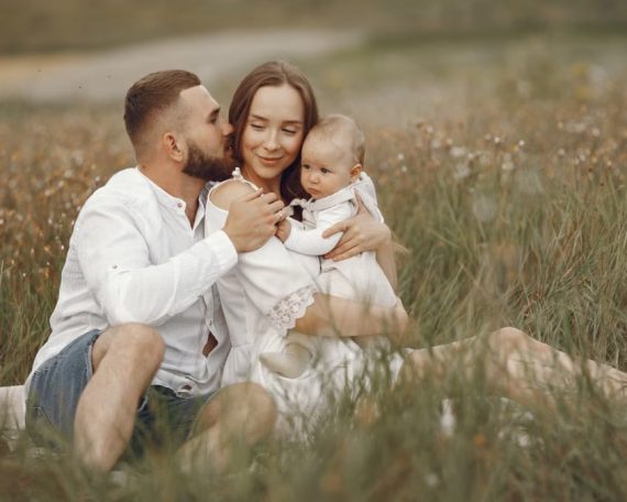 Happy family enjoying quality time in a serene meadow setting.